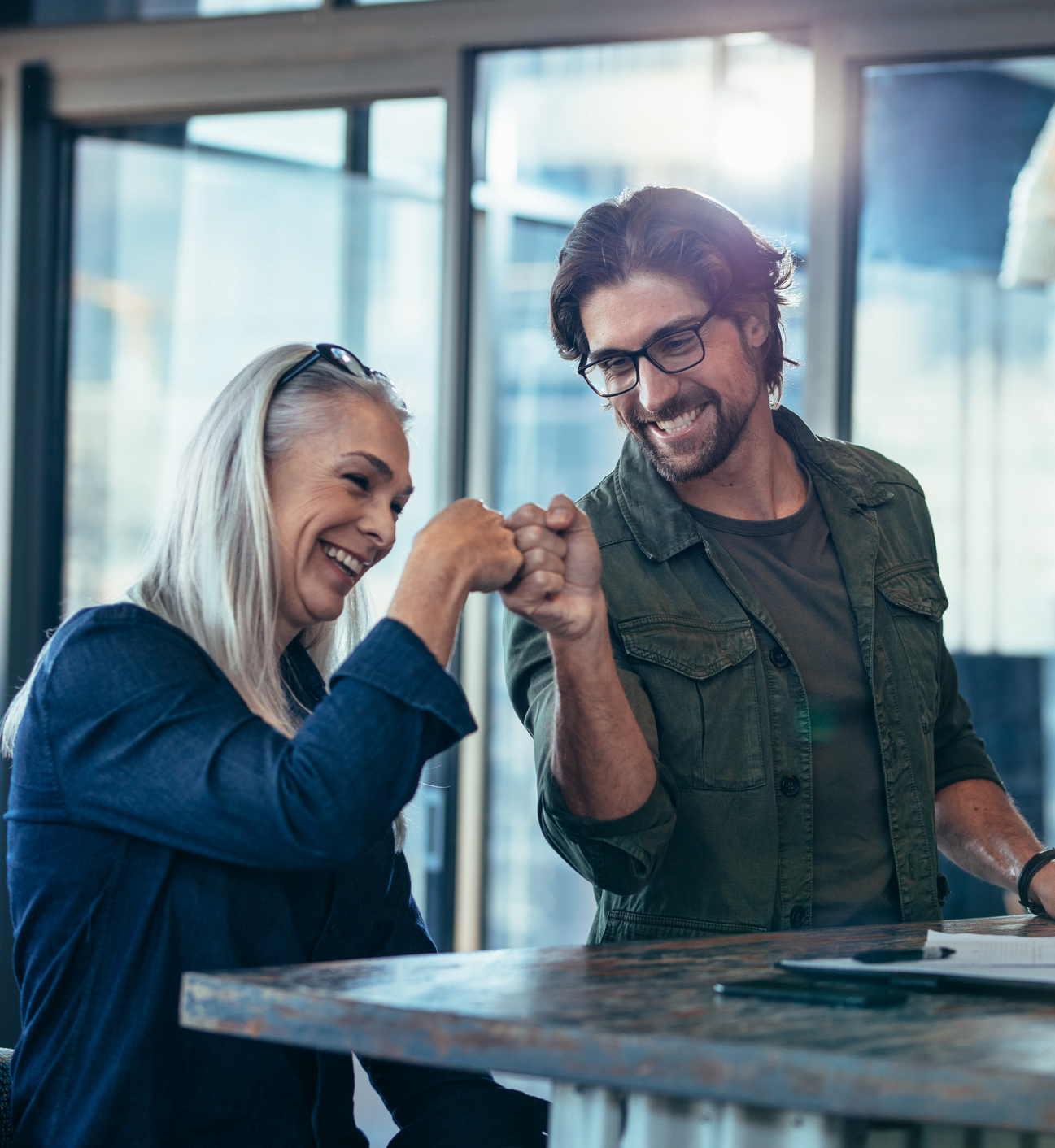 Business colleagues making a fist bump at office